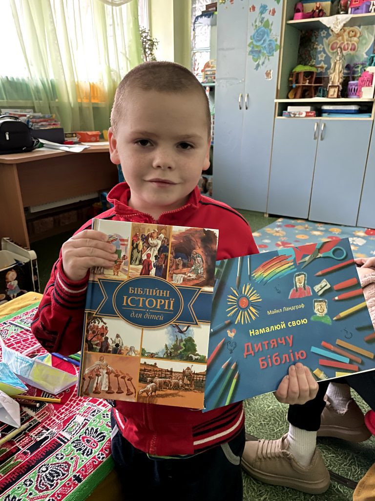 Oekraïense vluchteling met een kinderbijbel; foto: Vladyslav Sodel